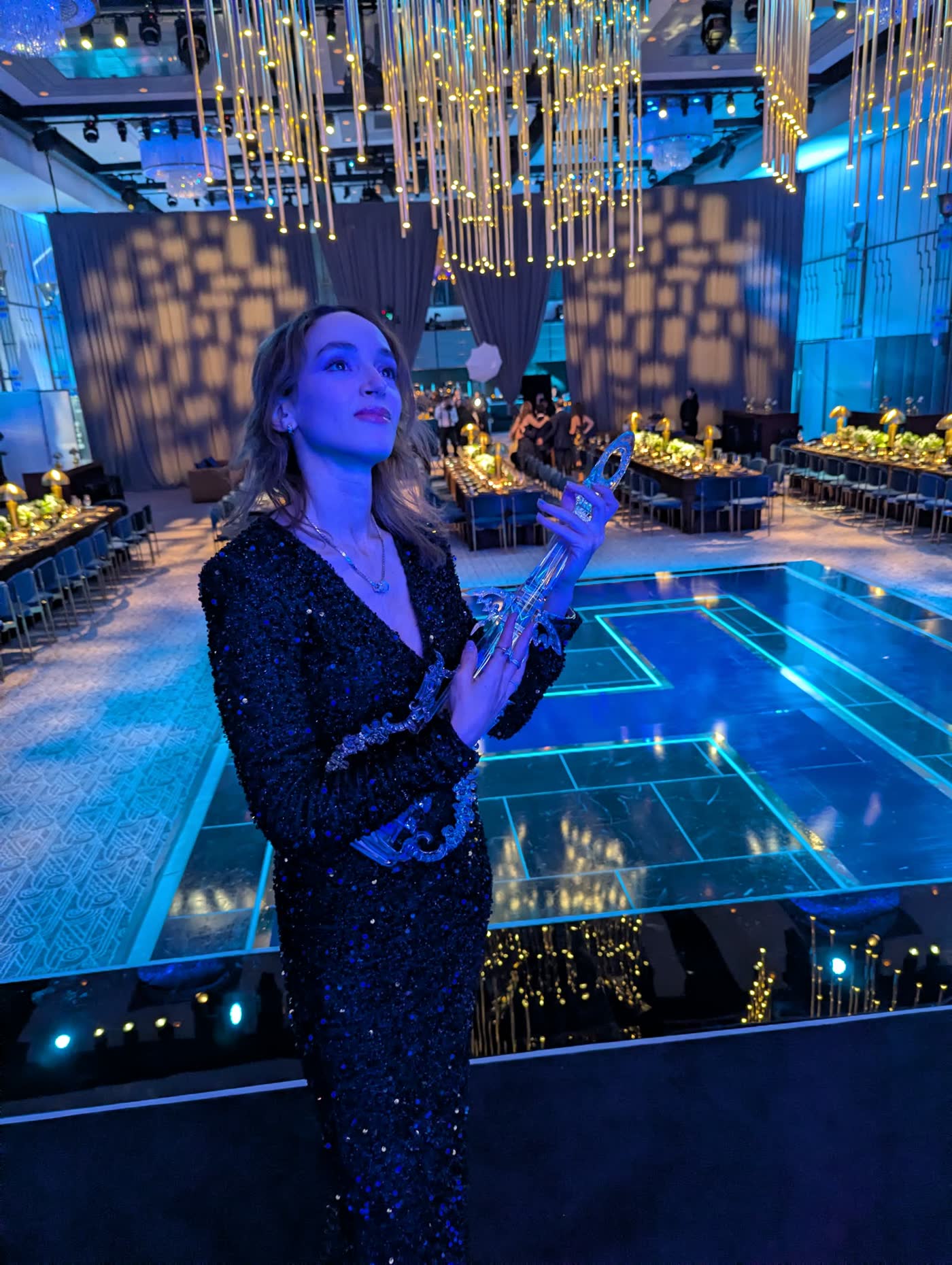 Sadie at the Ziegfeld Ballroom in New York, blue-lit glass dance floor and golden lights
